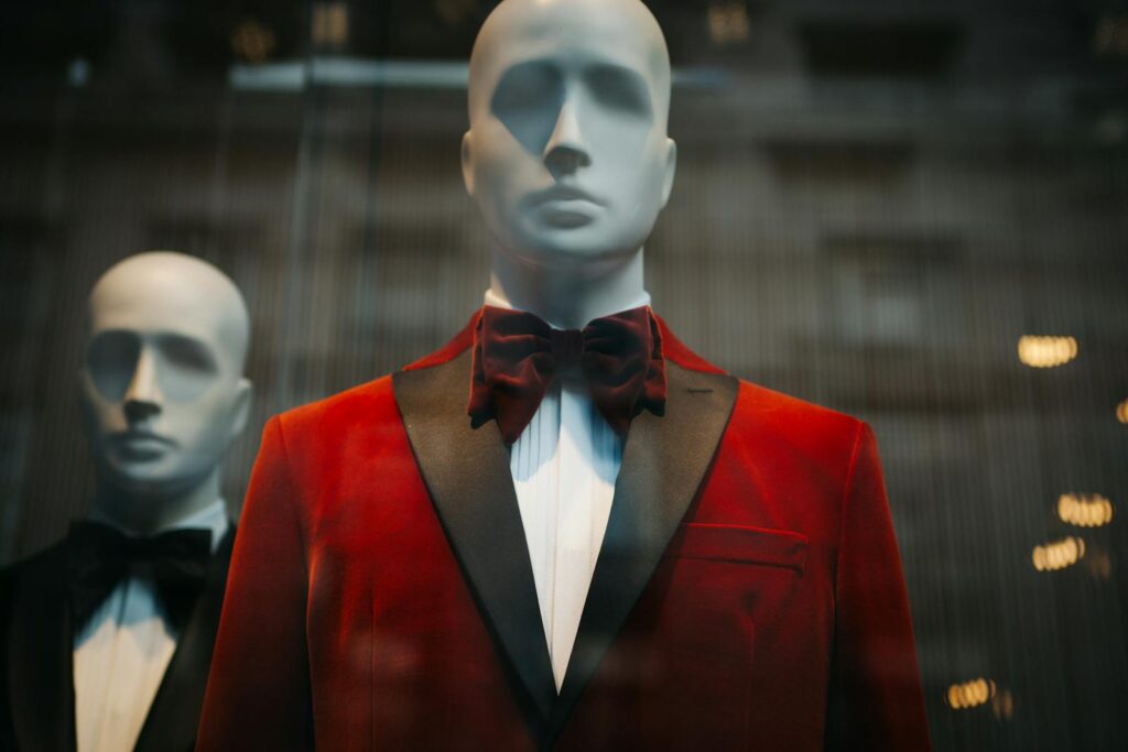 Stylish red tuxedo jackets showcased on mannequins, reflecting modern fashion.